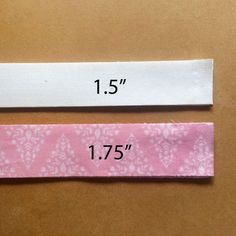 two white and pink ties with numbers on them