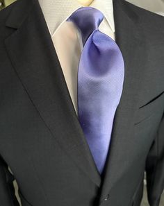 Solid ties are beautifully paired with the more busy of patters of bold stripes and heavy plaids. However, there is something so understated and elegant about a solid tie with a solid suit. Whether that be navy, charcoal or black a lavender tie fits well with a white shirt and even a navy blazer with jeans. Elegant Purple Neckwear For Black Tie Event, Formal Purple Standard Tie, Formal Black Suits With Ties, Black Suit With Ties For Formal Occasion, Classic Purple Neckwear For Formal Occasions, Formal Purple Neckwear With Ties, Classic Blue Suit For Black Tie Events, Elegant Black Tie Suits With Pocket Square, Elegant Black Tie Suit With Pocket Square