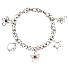 Stylish and finely detailed estate Tiffany & Co charm bracelet crafted in sterling silver. Peridot, pink tourmaline and iolite is estimated at 0.10 carats each. The out of production (circa 2003) gem set charm bracelet features a butterfly, moon, star, flower and dragonfly. Measuring 7 1/2 inches the bracelet is great for day or evening wear. The bracelet is in very good original condition and was recently professionally cleaned and polished. Particulars: Weight: 23.3 grams Stones: Peridot, pink Butterfly Moon, Tiffany And Co Bracelet, Vintage Tiffany, Flower Butterfly, Tiffany And Co, Silver Moon, Moon Star, Star Flower, Bracelet Crafts