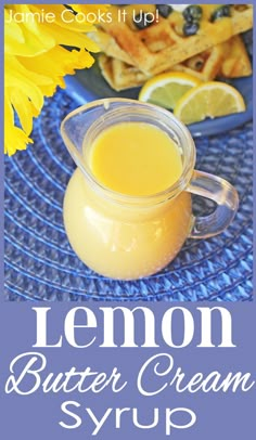 lemon butter cream syrup in a glass pitcher on a blue place mat with yellow flowers