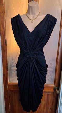 An absolutely stunning original 1940s cocktail dress. The original black wiggle dress. I bought this about twelve years ago from a vintage fashion dealer. I had it altered to fit my size 10 figure (9st, 34DD, 5'4" tall). I wore it once to a black tie/red carpet event and it certainly turned heads! It is beautifully draped from the shoulders and again at the hips. It is jet black - the photos make the drapes look faded but it is all the same colour. It has been in my wardrobe since which is such Black Wiggle Dress, Red Carpet Event, Black Cocktail, My Wardrobe, Wiggle Dress, Black Cocktail Dress, Dress Clothes For Women, Jet Black, Black Tie