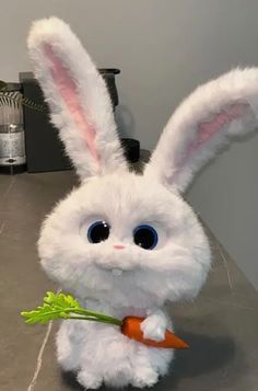 a white stuffed rabbit holding a carrot