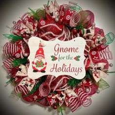 a christmas wreath that says gnome for the holidays with a santa hat and candy canes on it