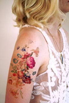 a woman with a flower tattoo on her arm