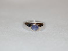 Our natural tanzanite cabochon ring set in silver with gold accents is simple and stylish. Created for anyone to wear and enjoy. 1.7ct oval tanzanite, sterling silver, size 11.5, inquire for other sizes Unique Birthstone Rings, Round Stone Ring, Mixed Metal Ring, Dope Jewelry, Tanzanite Ring, Purple Band, Cabochon Ring, Funky Jewelry, Jewelry Lookbook