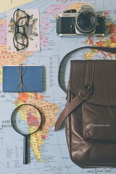 a travel poster with a map, camera and other items on it's surface