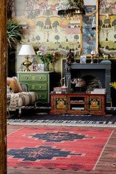 a living room filled with furniture and a fire place in front of a painting on the wall