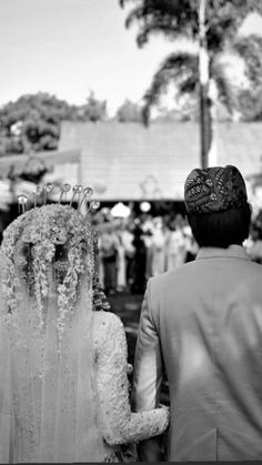 a bride and groom walking down the aisle at their wedding ceremony in black and white