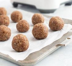 several balls of food sitting on top of a baking sheet next to a toaster