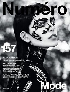 a woman with black makeup on the cover of a magazine