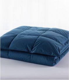 a blue comforter on a white background