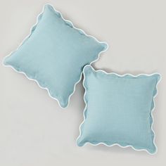 two light blue pillows with scalloped edges