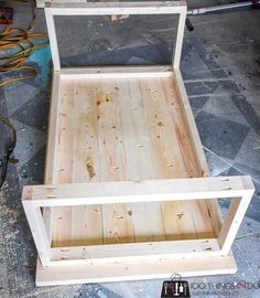 an unfinished bed frame sitting on top of a floor