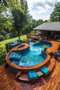 an above ground pool surrounded by wooden decking and blue cushions on top of it