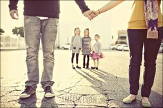 a group of people holding hands while standing in the street