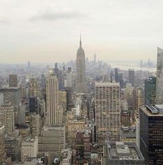 an aerial view of new york city with skyscrapers and the empire building in the background