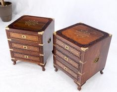 two wooden drawers with gold decorations on them