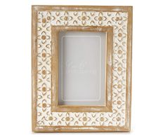 a wooden frame with an ornate pattern on the front and bottom, holding a white background