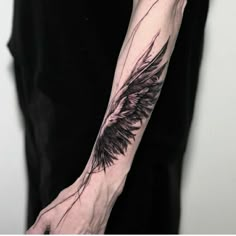 a person with a black and white tattoo on their arm