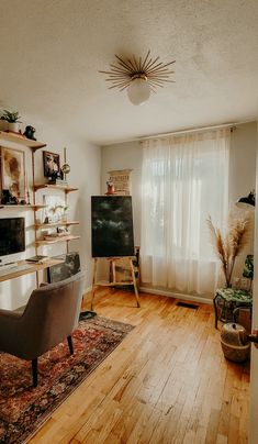 a living room filled with furniture and a flat screen tv on top of a wooden floor