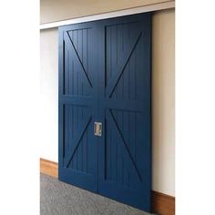 an open blue door in the corner of a room with carpeted floor and walls