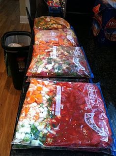 three bags of food are lined up on the floor