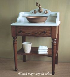 a white sink sitting on top of a wooden table