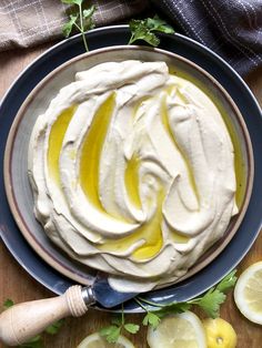 there is a plate with some lemons and whipped cream on it next to sliced lemons