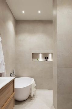 a white bath tub sitting next to a walk in shower