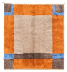 an orange, brown and blue rug with squares on it's edges is shown