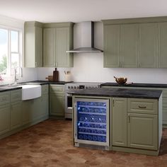 a wine cooler in the middle of a kitchen with lots of cabinets and counter space