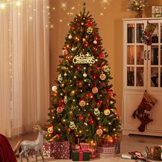 a decorated christmas tree in a living room with presents on the floor and lights around it