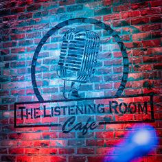 the listening room cafe sign is lit up with red and blue lights in front of a brick wall