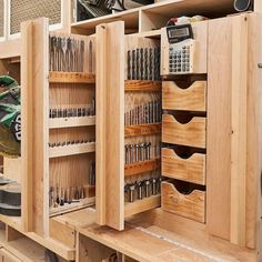 a workbench with many drawers and tools in it's storage compartment,