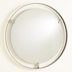 a round mirror mounted to the side of a wall