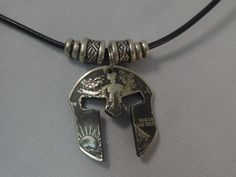 The pendant on this necklace is cut and shaped from an authentic Walking Liberty half dollar minted in the U.S.A.. The United States minted these coins from 1916 until 1943. The pendant is cut to resemble a Spartan mask. The Spartans were fierce warriors trained in honor and discipline between the 4th and 6th centuries BC. As you can see in the pictures, these brilliant coin necklaces are sure to catch the attention of anyone in the room. Features: Authentic 90% Silver Walking Liberty Half Dolla Coin Jewelry Diy, Cut Coin Jewelry, Mens Accessories Necklace, Coin Crafts, Silver Dollar Coin, Coin Art, Bold Jewelry, Morgan Silver Dollar, Coin Ring