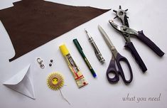 scissors, glue, and other crafting supplies laid out on a table