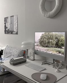 a desk with a computer monitor, keyboard and mouse sitting on it's side