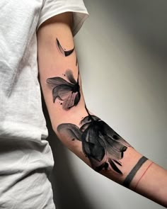 a person with a black and white tattoo on their arm