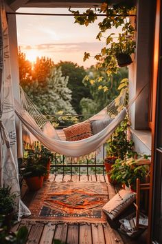 Cozy balcony with a hammock, potted plants, and a sunset view, draped with foliage and warm lighting. Balcony Ideas Apartment Hammock, Tiny Balcony Aesthetic, Apartment Balcony Dog Friendly, Cozy Window Seat