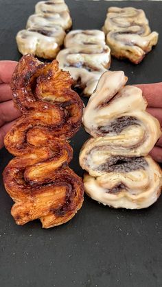 several different types of doughnuts being held in their hands