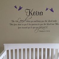 a baby's crib with a wall decal that says, keira