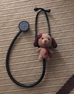 a stuffed dog is attached to a stethoscope