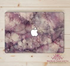 a macbook case with a purple marble design