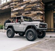 an off - road vehicle parked in front of a building