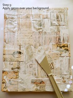 a white brush sitting on top of a piece of paper covered in words and pictures