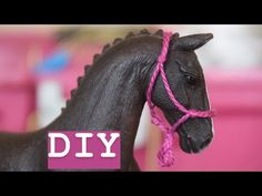 a black horse with a pink rope on its head and the words diy written above it