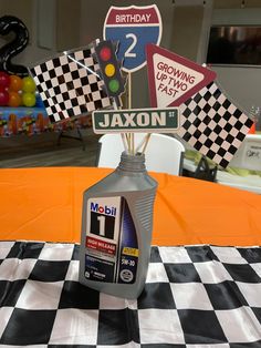 a motor oil bottle sitting on top of a checkered table cloth