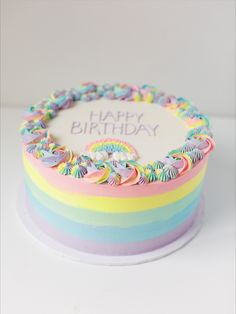 a birthday cake with rainbow frosting on top