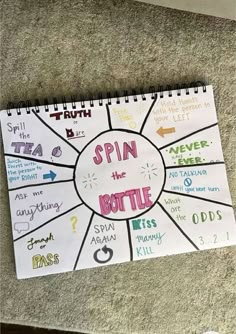 a spiral notebook with the words spin the bottle on it